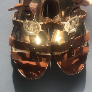 Michael Michael Kors caged cork brown and gold caged sandal wedges.